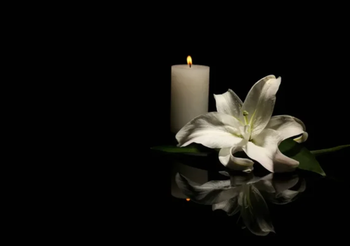depositphotos_208935100-stock-photo-beautiful-lily-burning-candle-dark
